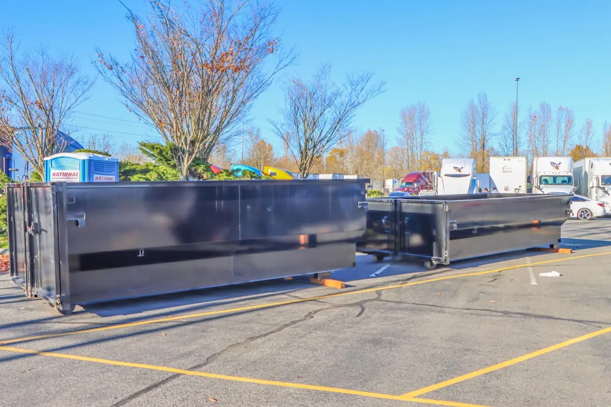 Professional dumpster rental service with roll-off container on residential driveway in Colebrookdale
